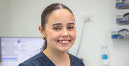 Smiling young woman in medical setting