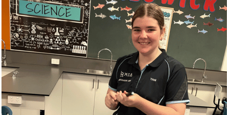 Smiling young woman in science classroom setting