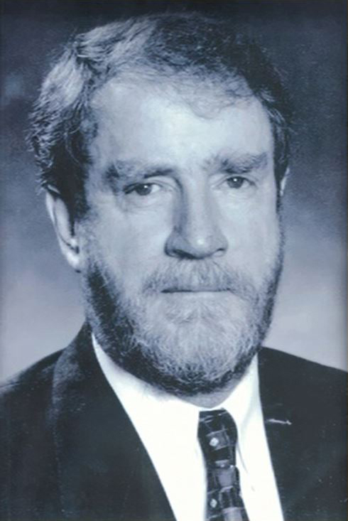 Image of Bob Marshman AM. Black and white photo of an older man with a beard, wearing a suit with a tie.